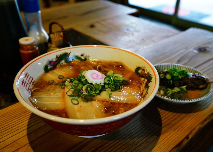 Bowl of Wakayama Ramen with a thick, concentrated broth and kamaboko on top